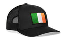 The Haka Hat Ireland Flag Trucker Hat features a black mesh design with a rectangular Irish flag patch—green, white, and orange stripes—on the front, and is finished with an adjustable snapback.