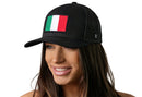A smiling woman wears the Haka Hat Italian Flag Trucker Hat, a black snapback by Haka Hat with an Italy embroidered flag patch on the front, shown against a white background.