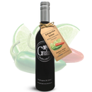 A dark bottle labeled Georgetown Olive Oil Co. Jalapeño Lime White Balsamic stands with a tag in front of faded images of lime slices and jalapeño peppers.