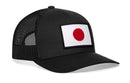 The Haka Hat Japanese Flag Trucker Hat | Black Japan Snapback features an embroidered red circle on white flag patch, black mesh panels, and an adjustable snapback closure for classic style and comfort.