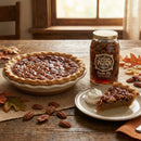 Pecan pie made from San Saba River Pecan Pie in a Jar with a slice on a plate and a jar of pecan pie filling on a wooden table.