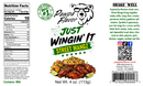 Product label for Pawpa Flavor Just Wingin’ It Street Wangz seasoning, featuring a nutrition facts panel, a bear logo wearing glasses, a serving suggestion of seasoned chicken wings and Mexican street corn, and social media icons with a QR code.