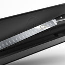 The SpitJack Deluxe Brisket Slicing Knife - 11 Inch Blade, Competition-Chef Series features a large chef’s-style blade with oval indentations and a black handle, presented in a black box and accented with SpitJack branding near the handle.