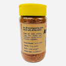 A transparent plastic spice jar with a yellow lid houses Culture Hot Sauce’s Kitchen Sink Rub—an all-in-one seasoning blend described as “the perfect match for everything from meats to veggies.” This flavorful blend from Culture Hot Sauce contains ingredients like garam masala, paprika, garlic, and the whimsical addition of the “kitchen sink,” delivering bold taste to any dish. Ideal as a BBQ seasoning or sprinkled over your favorite foods for an extra kick.
