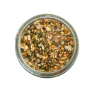 Top view of a glass jar of SALTOPIA Infused Sea Salts' KITCHEN'S KEEPER, an Italian Herbs & Garlic Salt blend with onion, orange peel, green herbs, and garlic salt, displayed on a white background.