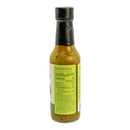 A glass bottle of handcrafted Powerful Pepper Company’s Serrano Kiwi & Tomatillo Hot Sauce with a black cap, featuring the nutrition facts and ingredients label on the side. The predominantly yellow label lists the ingredients and nutritional information for this vibrant hot sauce variety.