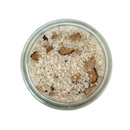 A glass jar of SALTOPIA Infused Sea Salts’ KROSSED KEYS Truffle Salt, blended with black Italian truffles, shown from above on a white background.