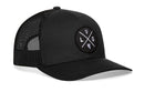 The Haka Hat Las Vegas Trucker Hat is a black mesh snapback with a curved brim and a front circular patch, featuring intersecting L V G letters.