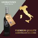 A bottle of Georgetown Olive Oil Co. LAVENDER ROSÉ White Balsamic Vinegar | Barrel Aged, Modena ITALY sits elegantly beside a gold map of Italy, featuring the text "Premium Quality Barrel Aged Modena Italian Balsamic.