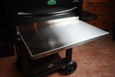 Pimp My Grill® Tactical Stainless Folding Front Shelf attached to a pellet grill as a stainless steel prep station.