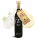 A bottle of Georgetown Olive Oil Co. LEMON GARLIC Infused | High Polyphenols Extra Virgin Olive Oil, featuring a tag and images of garlic and lemon in the background. This extra virgin olive oil, rich in polyphenols, is presented in a sleek black bottle with a silver cap and detailed white label—offering a vibrant fusion ideal for enhancing your favorite dishes.