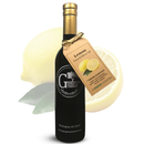 A bottle of Georgetown Olive Oil Co. Lemon Fused | High Polyphenols Extra Virgin Olive Oil, marked with a brown tag, displayed in front of a whole and sliced lemon.