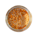 A glass jar of SALTOPIA Infused Sea Salts' Saltopia Hickory Maple Salt: LIP SMACKING GOOD, featuring orange and yellow seasoning granules, viewed from above on a white background.
