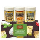 The SALTOPIA Cheese Lovers Gift Set features three cheese-infused sea salts—Parmesan Peppercorn, Cheddar & Chipotle, and Bleu Cheese—in a vibrant box with images of cheese and olives, perfect for gourmet seasoning enthusiasts.