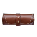 The Messermeister Folding Steak Knife Set in Leather Roll (4 Piece) features a brown leather pouch with white stitching and a brass-button strap, shown closed on a white background.