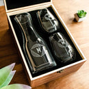 A Wine Decanter - The Modern gift set featuring a glass decanter and two stemless wine glasses, each etched with the letter M inside a geometric design and nestled in a wooden box.