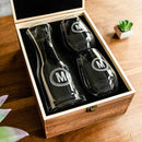 A Wine Decanter - The Medalist set including two engraved wine glasses, each featuring the letter M, resting in a wooden gift box.