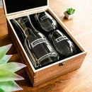 A Swanky Badger Wine Decanter - The Classic and two engraved wine glasses nestled inside an open wooden presentation box.