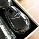 A Swanky Badger Wine Decanter - The Diamond, a clear glass diamond-shaped wine decanter with the name JASON engraved on the side, resting in a wooden gift box.