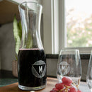 Swanky Badger Wine Decanter - The Modern filled with red wine and a matching glass, both etched with a circular monogram featuring the letter M.