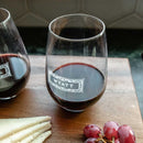 Two personalized Wine Decanter - The Classic stemless wine glasses filled with red wine, each featuring the name WYATT, set on a wooden board with cheese slices and red grapes.