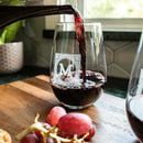 Red wine is poured from a Wine Decanter - The Heirloom into a stemless glass from a personalized gift set, etched with a decorative letter M.