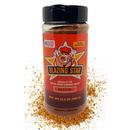 A bottle of Blazing Star BBQ’s Blazing Star Reaper Rub and Seasoning stands on a bed of spilled rub. The label showcases a smiling pig wearing a chef hat, with text highlighting its gluten-free and veteran-made qualities. This bold BBQ seasoning delivers intense heat with every sprinkle, making it ideal for spice enthusiasts craving an extra kick.