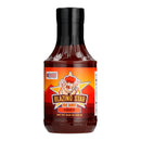 A bottle of Blazing Star BBQ Spicy Sauce from Blazing Star BBQ, featuring a cartoon pig chef on the label, set against a white background with flames at the bottom.