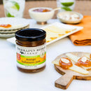 A quart jar of Terrapin Ridge Farms Mango Habanero Jam sits with cheese, crackers, and almond slices, creating an inviting tropical snack display featuring the sweet heat of Terrapin Ridge Farms.