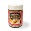 A 6 oz jar of SALTOPIA Infused Sea Salts—Maple Garlic & Thyme Salt: MAPLE ME CRAZY—features a white lid, red label, and adds sweet maple, garlic, and thyme flavor to your dishes.