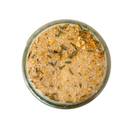 A top view of a SALTOPIA Infused Sea Salts glass jar filled with MAPLE ME CRAZY Maple Garlic & Thyme Salt—a gourmet blend—rests on a white background.