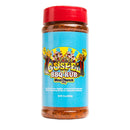 A 14oz container from the DDR BBQ Supply Top 10 Store-Bought BBQ Chicken Rubs Variety Pack, featuring a bright blue label, red lid, and cartoon illustrations of people in robes holding banners—perfect for anyone searching for championship chicken seasonings or looking to expand their chicken seasoning variety pack.
