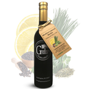 A bottle of Georgetown Olive Oil Co Mediterranean Herbs | High Polyphenols Extra Virgin Olive Oil, tagged and artfully arranged among lemon slices, chives, black peppercorns, sage, and fennel seeds. This distinctive olive oil from Georgetown Olive Oil Co. is crafted through a gentle cold infusion process that maintains the bright flavors of Mediterranean herbs while preserving the rich antioxidant benefits of its high polyphenol extra virgin olive oil base.