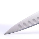Close-up of the pointed tip of a Messermeister Meridian Elite Kullens Carving Knife - 8", crafted from German stainless steel with oval indentations, photographed against a plain white background.