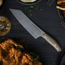 The Messermeister Carbon Next Level Block Set - 5 Piece by Messermeister is displayed on a dark table with fried chicken, mashed potatoes, herbs, a glass of whiskey with ice, and part of a hamburger on a plate.