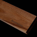 The Messermeister Wall Wood Knife Magnet Bar - 17.75", a rectangular Solomon Walnut block engraved with "Messermeister," is a stylish wall-mounted magnetic strip for knife organization, shown against a black background.