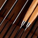 Close-up of two knives resting in the Messermeister In-Drawer Knife Holder - 11 Slot, highlighting smooth handles and sleek blades—an elegant Messermeister solution for stylish in-drawer knife storage.