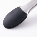 A close-up of the Messermeister Silicone Coated Locking Tongs - 9" shows black grips and a stainless steel handle against a white background.