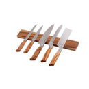 Five kitchen knives with wooden handles are elegantly displayed on the Messermeister Wall Wood Knife Magnet Bar - 17.75", showcasing various blade sizes and shapes along the branded walnut strip.