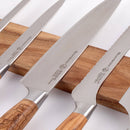 Four kitchen knives with stainless steel blades and wooden handles are arranged on the Messermeister Wall Wood Knife Magnet Bar - 17.75". The knives differ in blade shape and size.