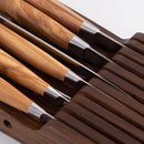 A close-up of the Messermeister In-Drawer Knife Holder - 11 Slot, showing knives neatly stored in a sleek wooden organizer, with slots and handles visible for elegant in-drawer storage by Messermeister.