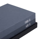 A close-up of the Messermeister Restoration Stone - 400 & 1000 Grit, with grit levels clearly labeled on its rectangular surface, set securely on a black base.