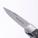 A close-up of the Messermeister Adventure Chef Linen Folding Peeler & Parer, featuring its metallic blade with the Messermeister brand engraved, set against a plain white background.
