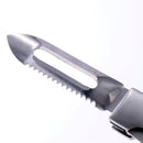 Close-up of the Messermeister Adventure Chef Linen Folding Peeler & Parer, a stainless steel multi-purpose tool with straight and serrated edges plus a central slot—ideal for camping, cutting, peeling, and outdoor cooking.