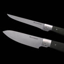 Two Messermeister Adventure Chef Linen Summit Set folding knives with dark handles and silver blades are shown against a black background—one features a pointed blade, the other a broader blade.