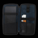 An open black zippered case reveals a notebook on the left and, on the right, a pen and two German stainless steel tools from the Messermeister Adventure Chef Maple Basecamp Set - 3 Piece, all secured with elastic bands.