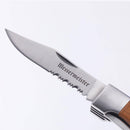 A close-up of the Messermeister Adventure Chef Maple Folding Camp Utensil, featuring a partially serrated blade and wooden handle with metal bolster by Messermeister, perfect for adventure chefs. The background is plain white.