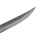 A close-up of a Messermeister Avanta Damascus Fine Edge Steak Knife blade, showcasing its wavy edge pattern and distinctive layered textures in the stainless steel.