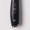 Close-up of the Messermeister Avanta Kendrick BBQ Knife - 8" featuring a dark wooden handle with two metal rivets and a metal end cap, designed to complement its German X50 stainless steel blade, set against a white background.