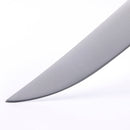A close-up of the pointed tip of a Messermeister Avanta Pakkawood Steak Knife, highlighting the fine-edge precision of this stainless steel blade from the 4-piece set against a white background.